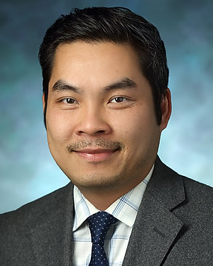 Portrait of Doan Dao wearing suit and tie.
