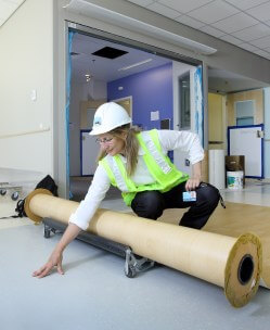 Hopkins architect Marge Smith checks out the rubber flooring in the neonatal intensive care unit, designed to tamp down noise for babies and families. 