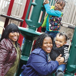 Noy Brown and Aisha Frisby with daughters Marley and Karter on playground