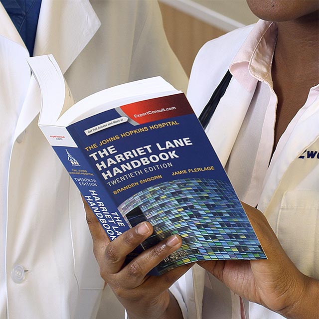 Physicians holding handbook