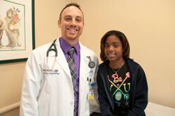 Zoe Solomon, a 12-year old from Grand Cayman Island, stands with her cardiologist Jamie Decker. Solomon had a new pacemaker implanted at All Children's Hospital and will return for follow-up visits.