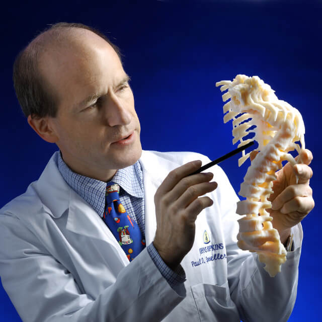 Dr. Sponseller holding a model of a deformed spine