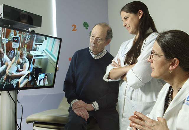 doctors conducting telemedicine with a patient