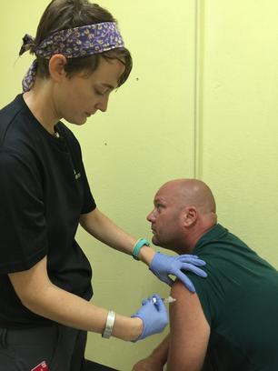 A member of the Johns Hopkins Go Team administers a tetanus shot