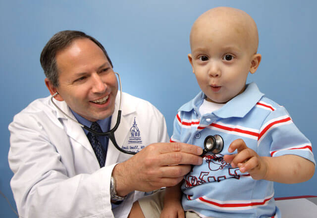 Donald Small, M.D. with pediatric oncology patient