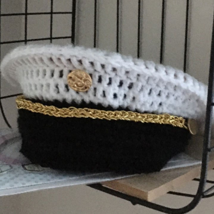 A crocheted U.S. Naval Academy hat.