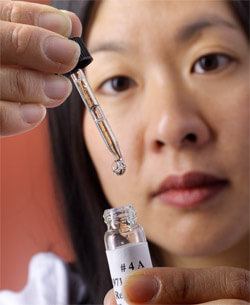 Sandra Lin holding vial of allergy drops.