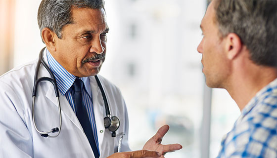 male doctor speaking to male patient