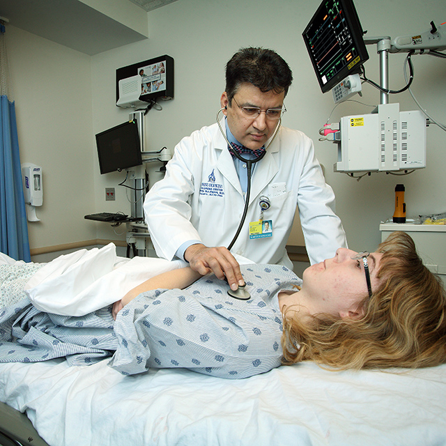 Pediatric anesthesiologist Irfan Suleman examines a patient.