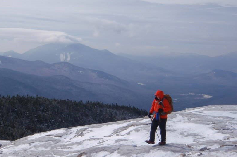 Craig hiking atop a snowy mountain