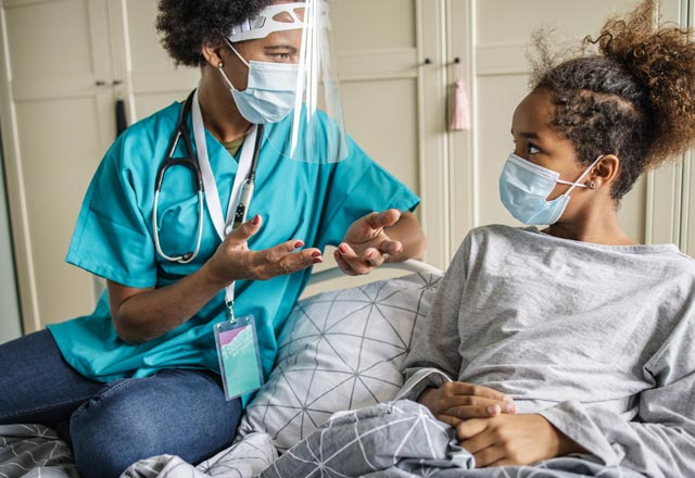 Pediatric nurse talking with a pre-teen home care patient
