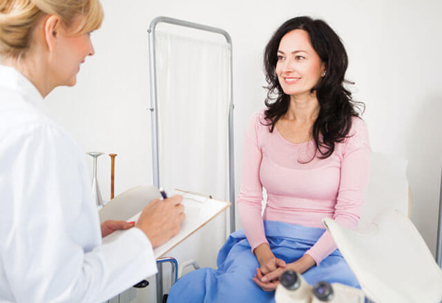 Female doctor consults with female patient in clinic