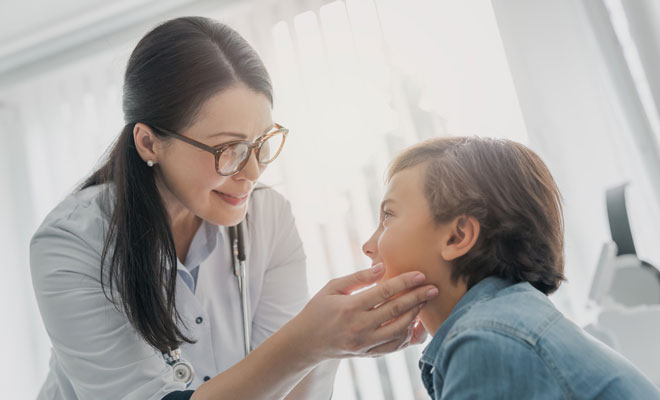 pediatrician examining little boy