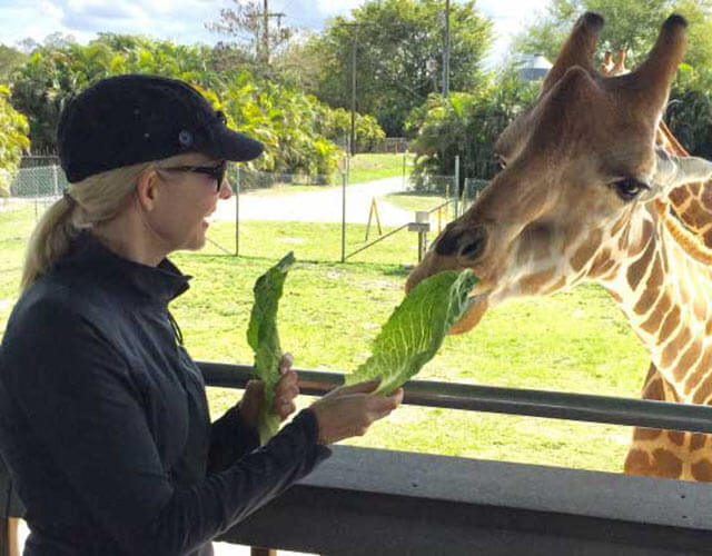 Susan feeding a giraffe. 