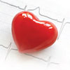 Shiny red plastic heart sitting on EKG results