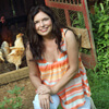 Eva Sherman Hejazi posing at her home in front of her chicken coop