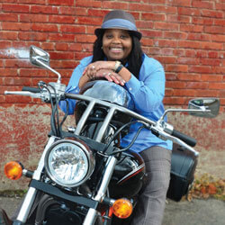 Nikki Jones smiling as she sits on her motorcycle