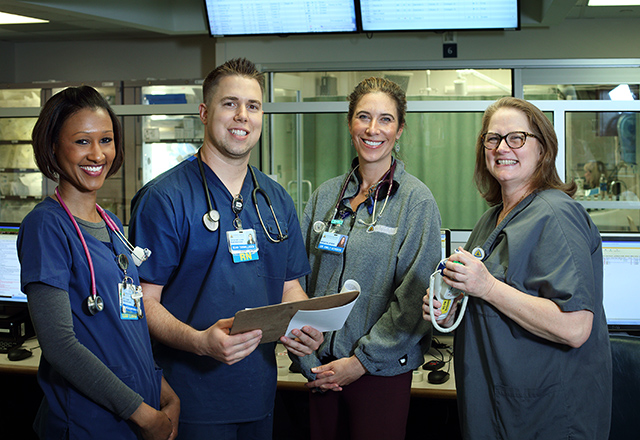 A group of nursing staff smile together.