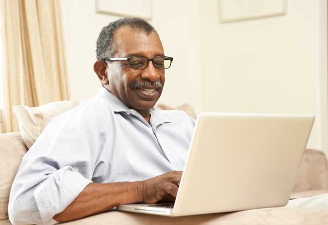 happy man using laptop